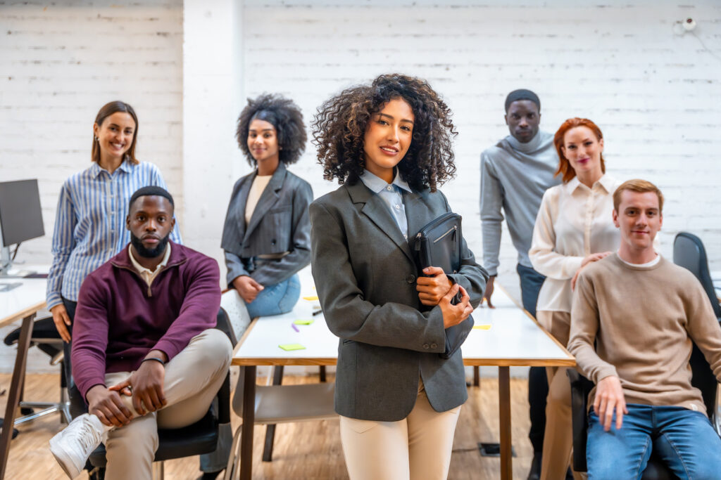 female-leader-standing-next-to-teamwork-in-a-cowor-2024-12-10-03-07-58-utc